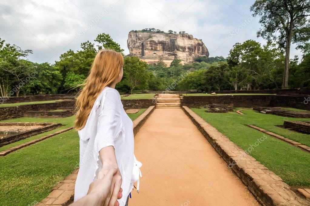Sigiriya, Sri Lanka. Girl leads (follow me) by the hand to the r