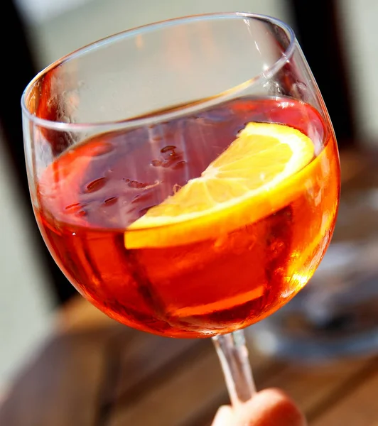 Glass of aperol in hand — Stock Photo, Image