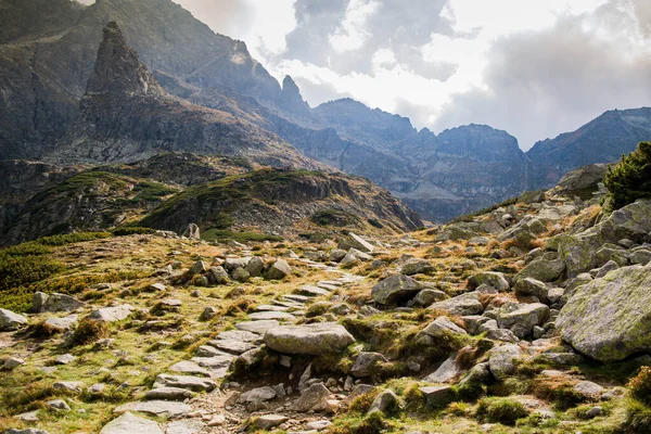 Path in the Tatra Mountains. Hiking around the rocks. Climbing a mountain peak.