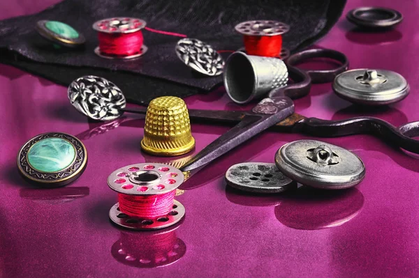 Sewing accessories on purple background — Stock Photo, Image