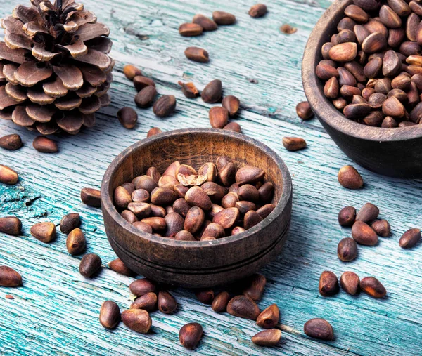 Unpeeled cedar nut in mortar — Stock Photo, Image