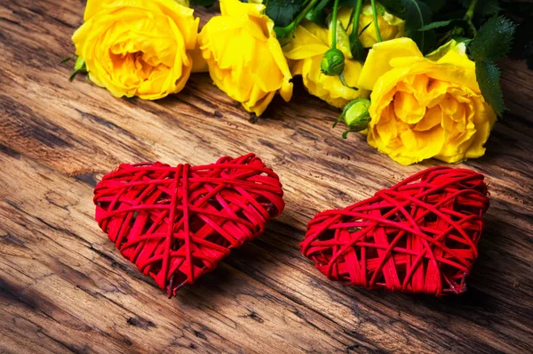 Spring flowers and symbolic red hearts — Stock Photo, Image