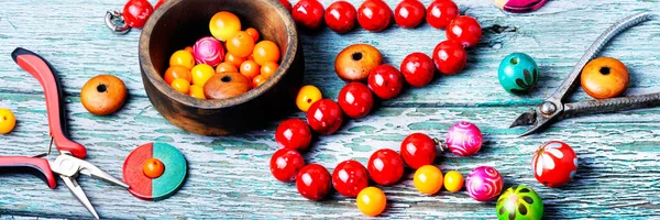 Making necklaces of colored beads