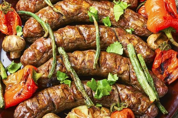 Delicious german sausages with grilled mushrooms and tomatoes.BBQ with sausage