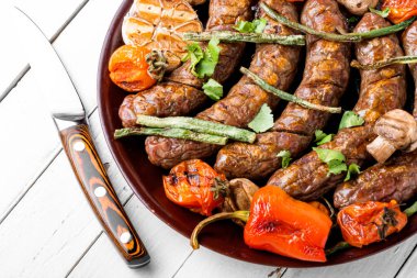 Izgara mantar ve domatesli lezzetli Alman sosisleri.