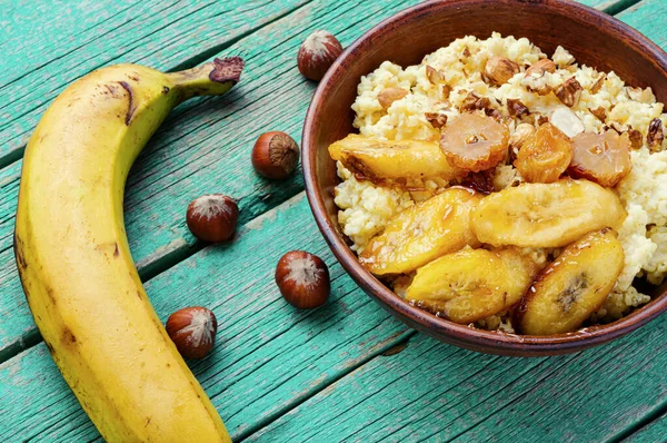 Millet porridge with caramelized bananas and nuts.Healthy breakfast