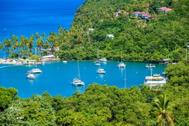 Close view of Marigot Bay with cruise yachts, west coast of Caribbean island of St Lucia. clipart