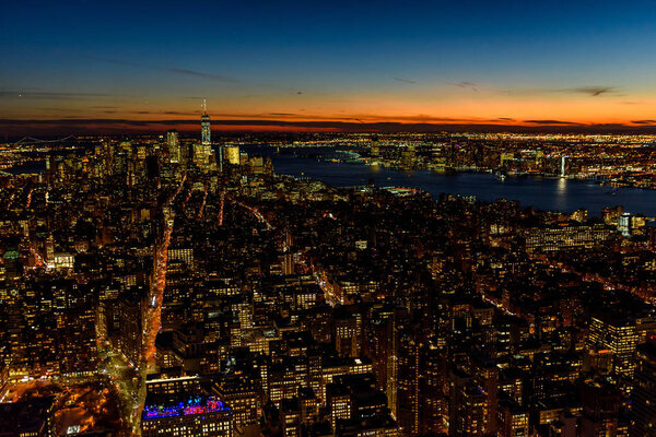Aerial view of Manhattan downtown skyline with skyscrapers at dusk, New York City, USA.