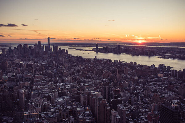 Aerial view of Manhattan downtown skyline with skyscrapers at dusk, New York City, USA.