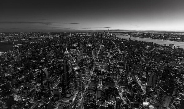 Black and white view of Manhattan downtown skyline with skyscrapers at twilight, New York City, USA.