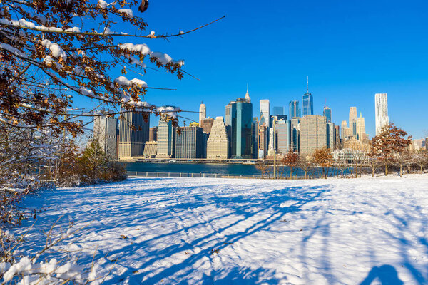 Lower Manhattan skyline panorama in snowy winter time, New York City, USA.
