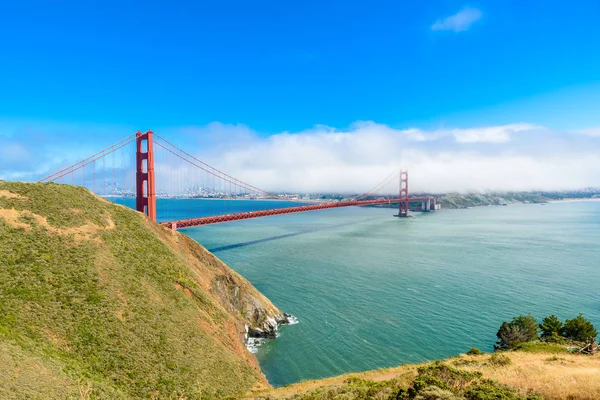 Golden Gate Bridge with the skyline of San Francisco in the background on a beautiful sunny day with blue sky and clouds in summer - Panoramic view from Battery Spencer - San Fancisco Bay Area,  Golden Gate National Recreation Area, California, USA
