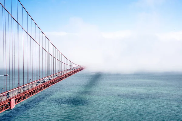 Golden Gate Bridge in clouds in summer day, view from Battery Spencer, California, USA.