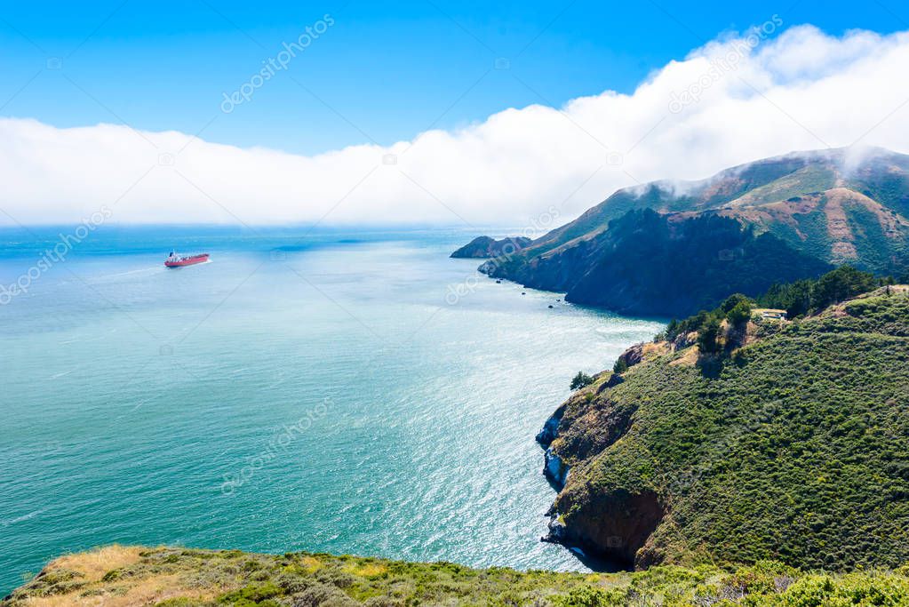 Coast at Golden Gate Bridge in clouds on a beautiful summer day  - Panoramic view from Battery Spencer - San Fancisco Bay Area,  Golden Gate National Recreation Area, California, USA