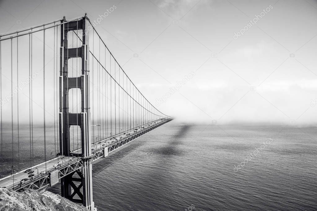 Golden Gate Bridge in clouds in summer day, view from Battery Spencer, California, USA.