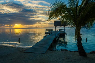 Sunset at South Water Caye - small tropical island at Barrier Reef, Caribbean Sea, Belize, Central America. clipart