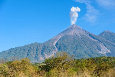 Amazing volcano El Fuego during a eruption on the left and the Acatenango volcano on the right, view from Antigua, Guatemala clipart