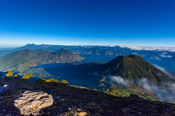 Panoramic view of Lake Atitlan and volcano San Pedro and Toliman early in morning from peak of volcano Atitlan, Guatemala.