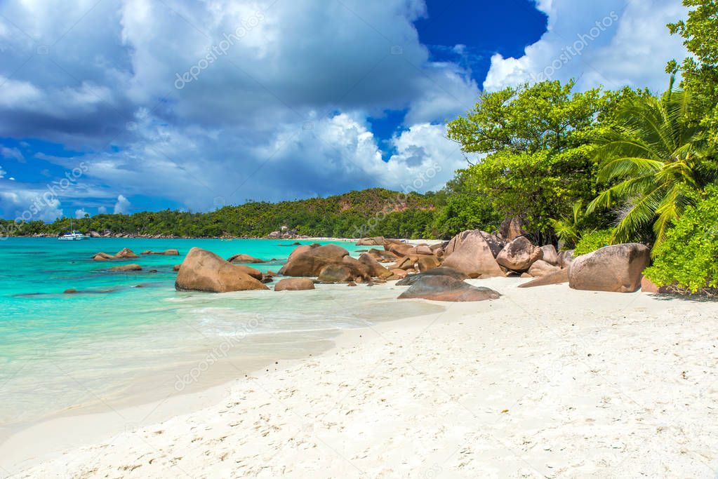 Anse Lazio - Paradise beach with white sand, turquoise water, rich green trees and stones, Seychelles.