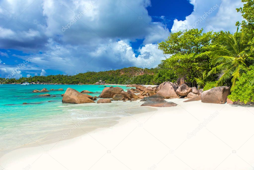 Anse Lazio - Paradise beach with white sand, turquoise water, rich green trees and stones, Seychelles.