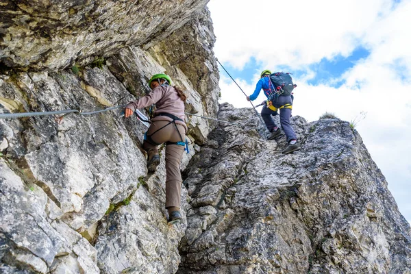 Hiker climbing in the mountain of Alps, Europe