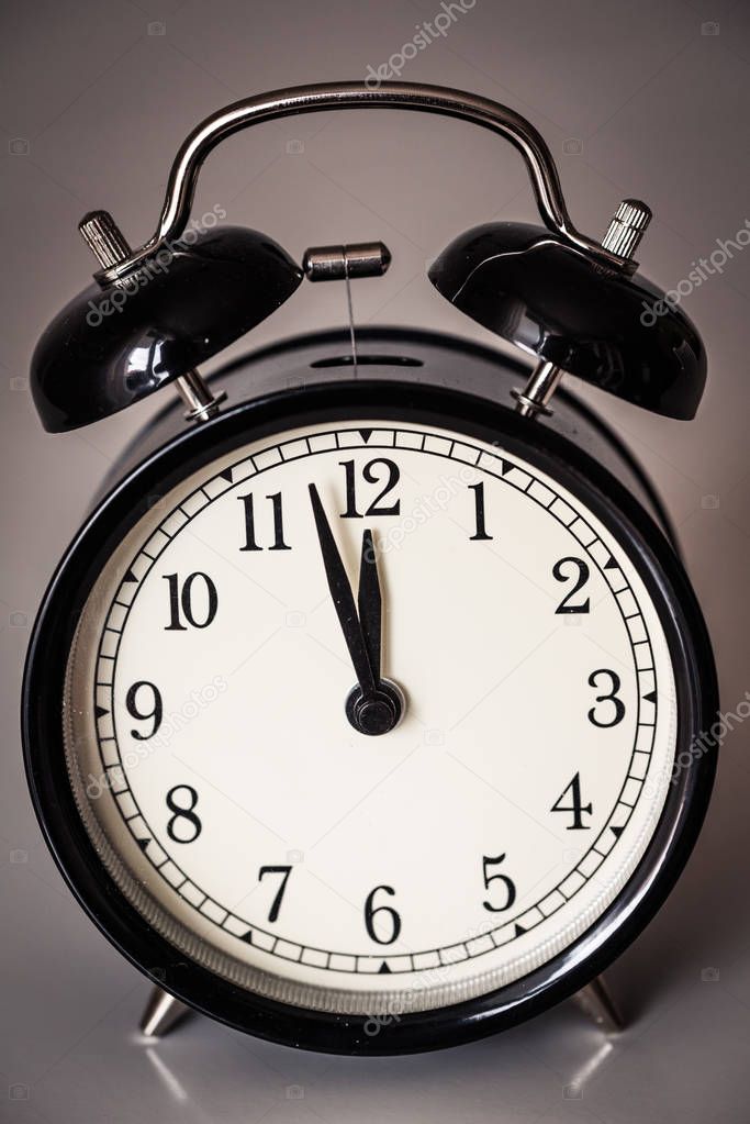 Closeup of alarm clock on grey surface