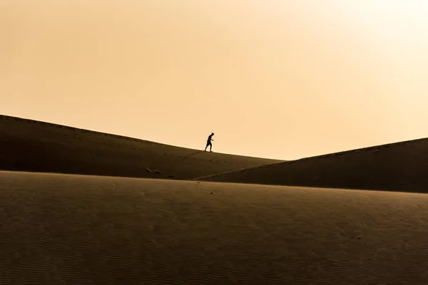Man walking in the desert of gran canaria, Spain