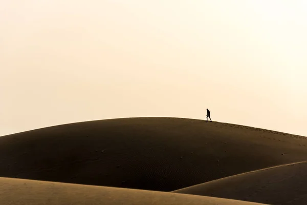 Man walking in the desert of gran canaria, Spain