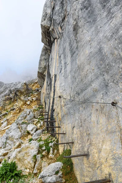 Iron stairs and hiking path to Ellmauer Halt at Wilder Kaiser mountains of Austria - close to Gruttenhuette, Going, Tyrol, Austria - Hiking in the Alps of Europe