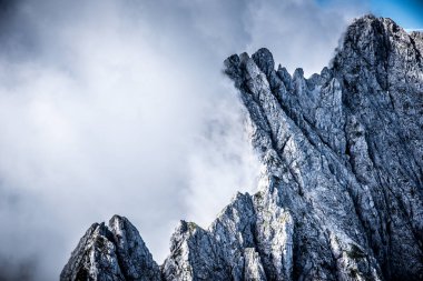 Mountains in clouds at Ellmauer Halt, Wilder Kaiser mountains of Austria - close to Gruttenhuette, Going, Tyrol, Austria - Hiking in the Alps of Europe clipart