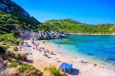 Porto Timoni 'nin Afionas plajı, Korfu, İkiz Koyu, İyon Adası, Yunanistan ve Avrupa' da kristal berrak gök mavisi suyu bulunan bir cennet çifte kumsalı.