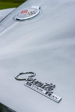Emblem of the sports car Chevrolet Corvette Sting Ray Coupe, closeup. clipart