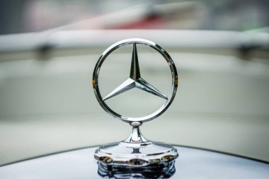The famous three-beam star of Mercedes-Benz. Hood ornament, close-up. clipart