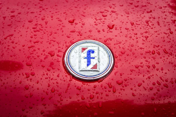Státní znak italské carrozzeria Pininfarina na Fiat 124 Sport Spider v dešťové kapky. — Stock fotografie