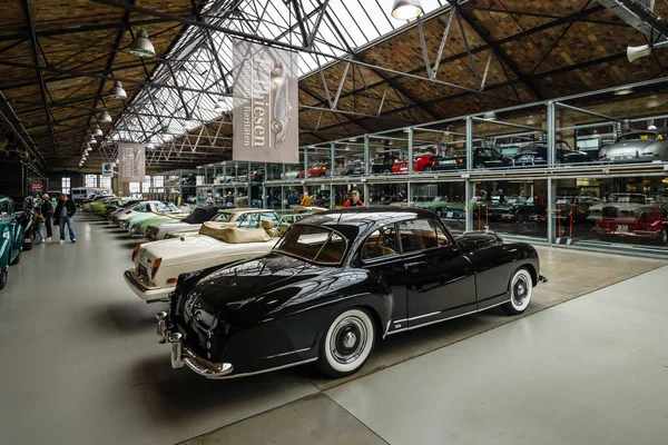 Various retro cars stand in a row in the pavilion of the center of competence for classic cars and youngtimers - Classic Remise. Stock Image