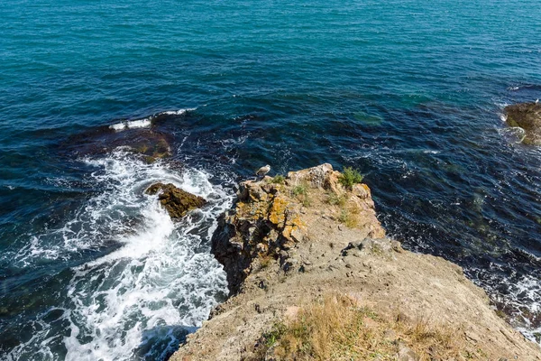 Mavi deniz, dalgalar ve kayalık sahil. — Stok fotoğraf