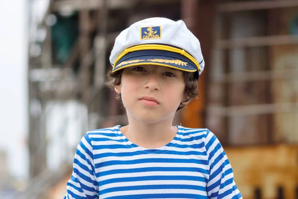 Portrait of a boy in a striped long sleeve T-Shirt (Telnyashka) and captain's cap. — Stock Photo, Image