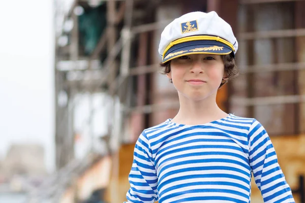 Portrait of a boy in a striped long sleeve T-Shirt (Telnyashka) and captain's cap. — Stock Photo, Image