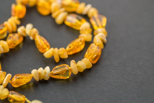 Amber necklace on dark. — Stock Photo, Image