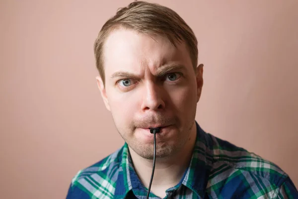 Young man with computer cable. — Stock Photo, Image