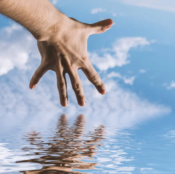 Hand of a man reflecting in water surface. — Stock Photo, Image