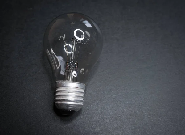 Incandescent lamp on a dark. — Stock Photo, Image