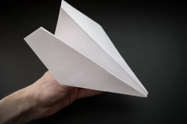 Бумажный Самолет Руке Темном Фоне — стоковое фото