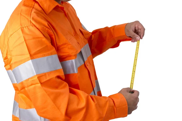 Supervisor with tape measure wearing high visibility shirt on a — Stock Photo, Image