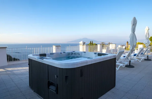 Bañera de hidromasaje en una azotea del complejo con vistas al mar Mediterráneo y al Vesubio, Sorrento, Italia Imagen de stock