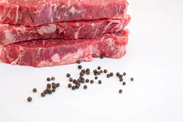 Raw Beef Strip Loins Steak Some Black Pepper Corns White — Stock Photo, Image
