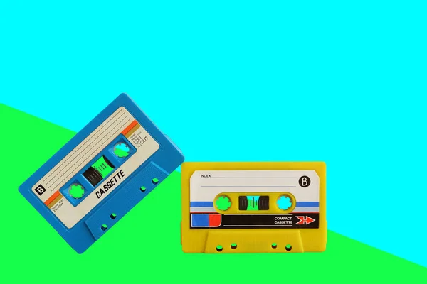 Old colorful cassette audio tape on pastel color background, and leave blank space above for text input.