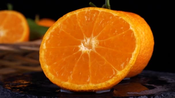 Video footage of the concept of a healthy food and diet. Spinning sliced oranges — ストック動画