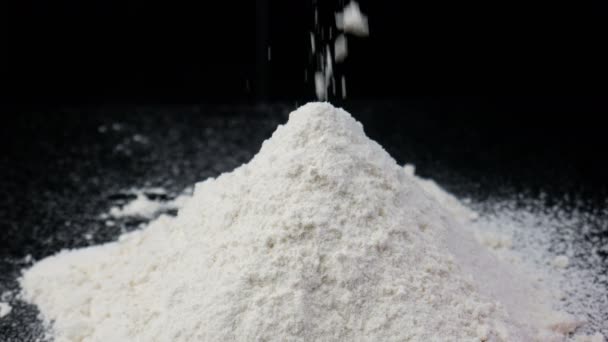 A pile of flour on the black background — Stock Video