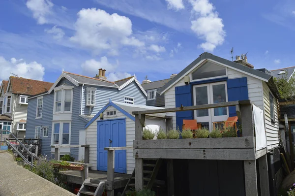 stock image WHITSTABLE, UK-JULY 22: A row of traditional weather boarded houses along Whitstable sea front. Whitstable has been named as a property hot spot in 2017.. July 22, 2017 Whitstable, Kent, UK.